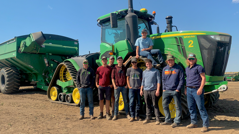 Plant Ag students standing in front of a green tractor