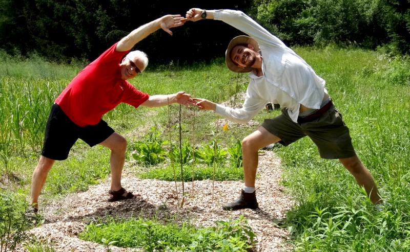 Paul Wartman and Ralph Martin stretching in the Edible Forest Garden 