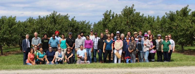 Group photo in front of the orchard