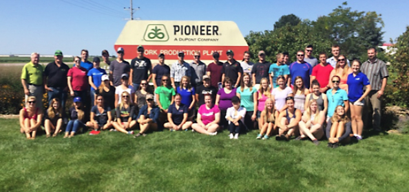 MidWest tour group in front of DuPont Pioneer’s York Nebraska seed production facility sign