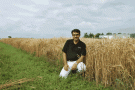 Ali Navabi in a field of wheat
