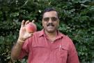 Dr. Subramanian holding a peach.