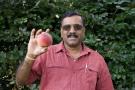 Dr. Jay Subramanian holding a peach