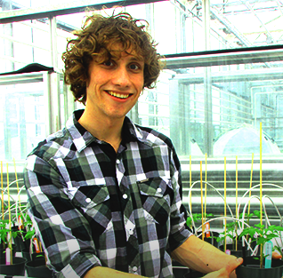 Travis Cranmer in a greenhouse